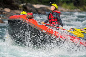Girl are rafting in river, big watersplash over boat. Extreme sports, water activity and adrenaline concept.