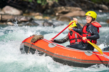 Girl are rafting in river. Extreme sports, water activity and adrenaline concept.