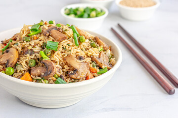 Asian Vegetable and Mushroom Fried Rice in a Bowl on White Background 