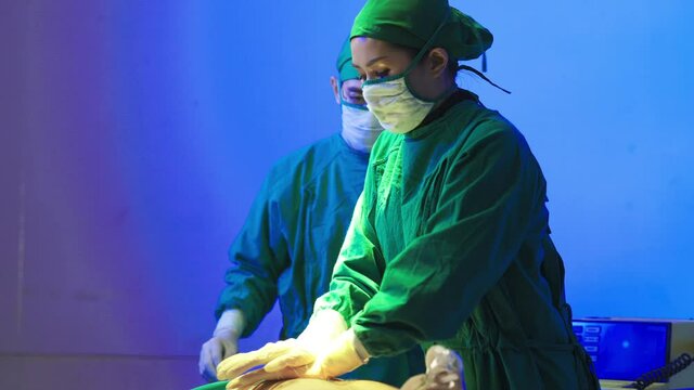 Surgeon assistant with efibrillating in emergency room. Healthcare and medical concept.