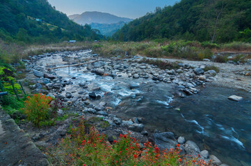 Beautiful Reshi River water flowing through stones and rocks at dawn, Sikkim, India. Reshi is one of the most famous rivers of Sikkim flowing through the state and serving water to many local people.