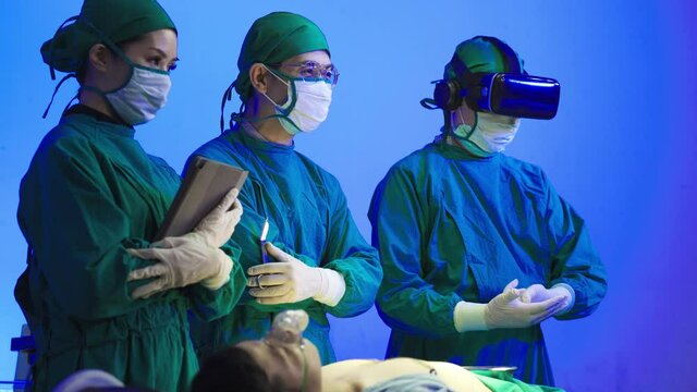 VR Glasses and Headsets, Modern Technology of Virtual Reality for the Future. Medical surgery team in the operating room. Assistants and Nurses Performing Surgery.