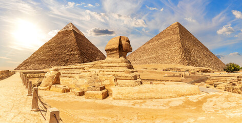 Fototapeta na wymiar The Sphinx in front of Pyramids of Egypt, beautiful panoramic view
