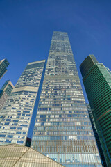 Naklejka premium Skyscrapers in the business center, financial district, sunny day, blue sky, empty space, Moscow city, Russia.