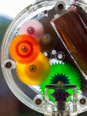 Macro photography of the cog mechanism of a rainbow maker machine glued to a window in a house near the colonial town of Villa de Leyva in central Colombia.
