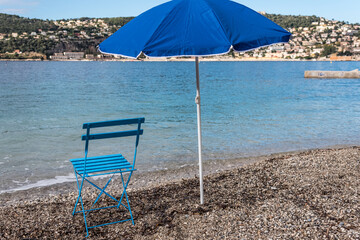 beach blue chair and an umbrella