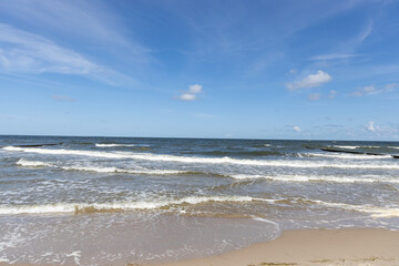 Fototapeta na wymiar High and dangerous waves on the beach of Zempin on the island of Usedom on a beautiful day