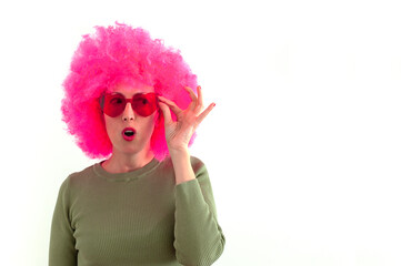 Woman wearing a pink wig and heart shaped red glasses on white background