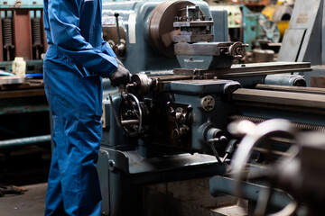 Mechanical Engineering control lathe machine in factory facility. Safety First at work place.