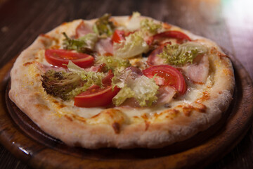 Close up of delicious pizza with salad and sliced ham
