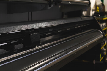 Modern plotter laser cutter machine in print house industry, close-up view photo