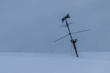 old antenna on the roof of a house in winter