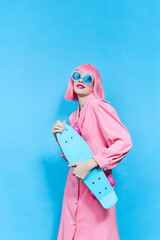 pretty woman in sunglasses wears a pink wig studio model unaltered