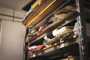 Printing house warehouse and metal shelf with different type of paper. Working process, printing indutry concept photo