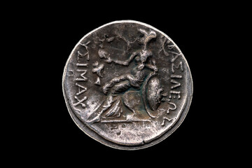 Reverse side of a Greek silver Drachum coin replica of  Alexander the Great dated from 336-323 BC cut out and isolated on a black background, stock photo image © Tony Baggett