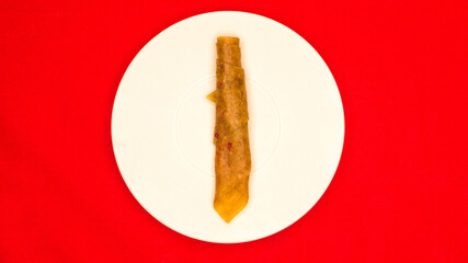 
Fruit pastila on a plate, photo on a red background