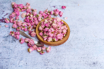 Fototapeta na wymiar Flower tea rose buds on gray textured background with copy space 