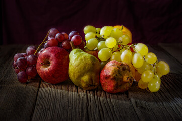 Still life fruits on wooden table,pear, apple, pomegranate, mandarin. 