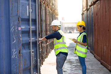 Hispanic Man worker and woman Supervisor dock cargo checking and control loading Containers box at container yard port of import and export goods. Unity and teamwork concept