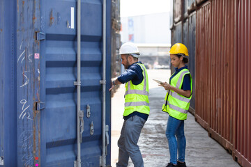 Hispanic Man worker and woman Supervisor dock cargo checking and control loading Containers box at container yard port of import and export goods. Unity and teamwork concept