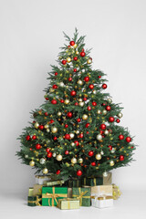 Fototapeta na wymiar Beautiful Christmas tree and gift boxes on white background