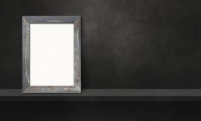 Wooden picture frame leaning on a black shelf. 3d illustration. Horizontal banner