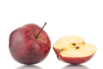 One whole and one half of a ripe red apple, close-up, isolated on white.