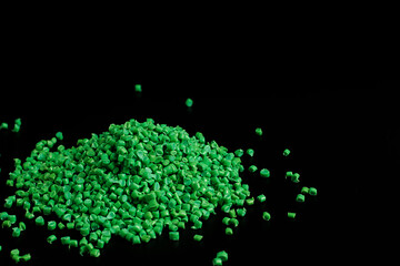 Green granules of polypropylene, polyamide. Background. Plastic and polymer industry. Microplastic products.