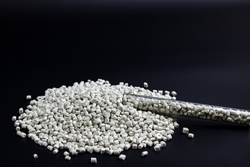 white granules of polypropylene, polyamide in a test tube. Background. Plastic and polymer...