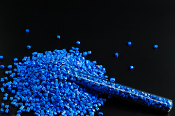 Blue granules of polypropylene, polyamide in a test tube. Background. Plastic and polymer industry....