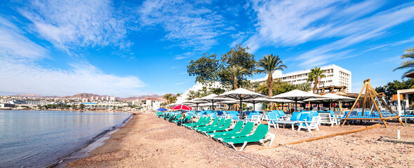 Fototapeta na wymiar Morning on sandy beach in Eilat - famous tourist resort and recreational city in Israel