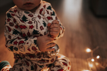 christmas decoration in the hands of a toddler