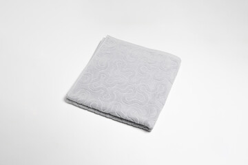 Folded soft towel isolated on white background.High resolution photo.Top view. Mock-up.