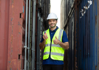 foreman manager working through a radio communication with the workers in the container yard at...