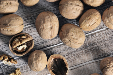 walnuts in a shell on a wooden background - top view