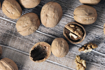 walnuts in a shell on a wooden background - top view