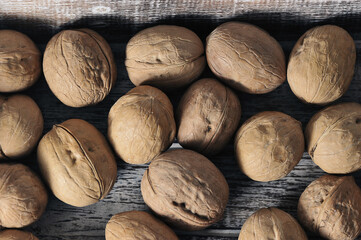 walnuts in a shell on a wooden background - top view