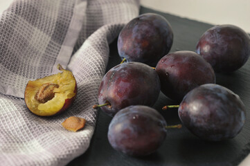 ripe plums on a black background