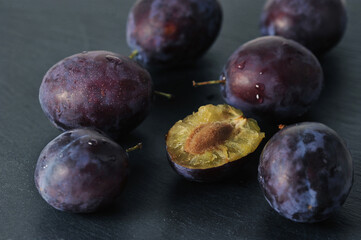 ripe plums on a black background