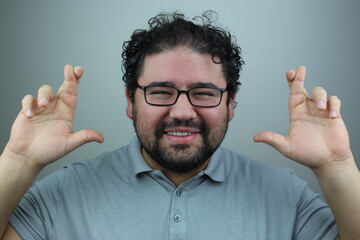 happy young man crossing his fingers