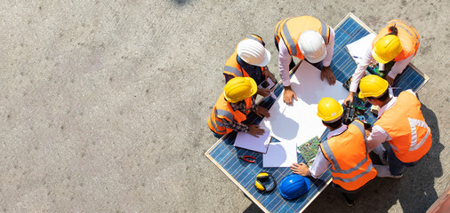 Ethnic diversity worker people, Success teamwork. Group of professional engineering people wearing hardhat safety helmet meeting with solar photovoltaic panels discussion in new project - Powered by Adobe