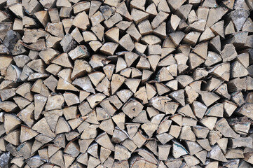 birch firewood stacked in a woodpile - stocks of firewood for the winter