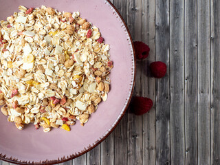Muesli in a cup on a wooden table. Muesli on a wooden background.