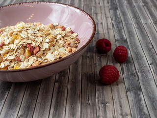 Muesli in a cup on a wooden table. Muesli on a wooden background.