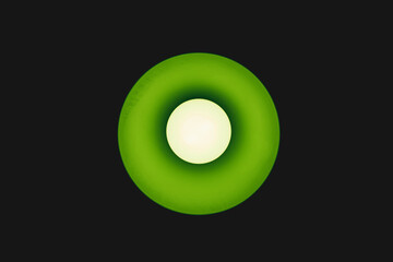 green light from the bulb on the ceiling