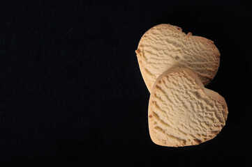 heart-shaped cookies on a black background