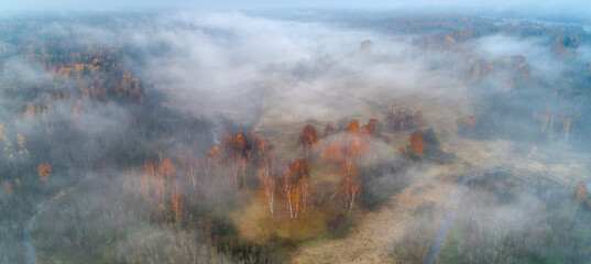 Autumn dawn over foggy forest and river aerial drone view