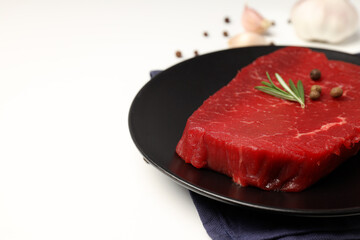 Concept of cooking with raw steak on white background
