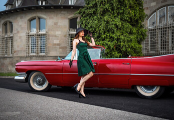 Old-timer red Cadillac and a beautiful young girl