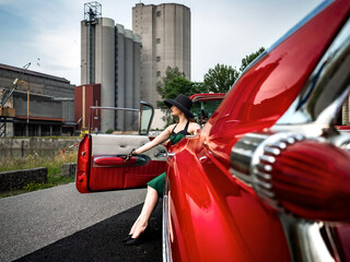 Old-timer red Cadillac and a beautiful young girl